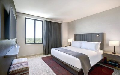 King bed with lounge area and natural light at Fairfield Inn & Suites By Marriott Kenosha Pleasant Prairie.