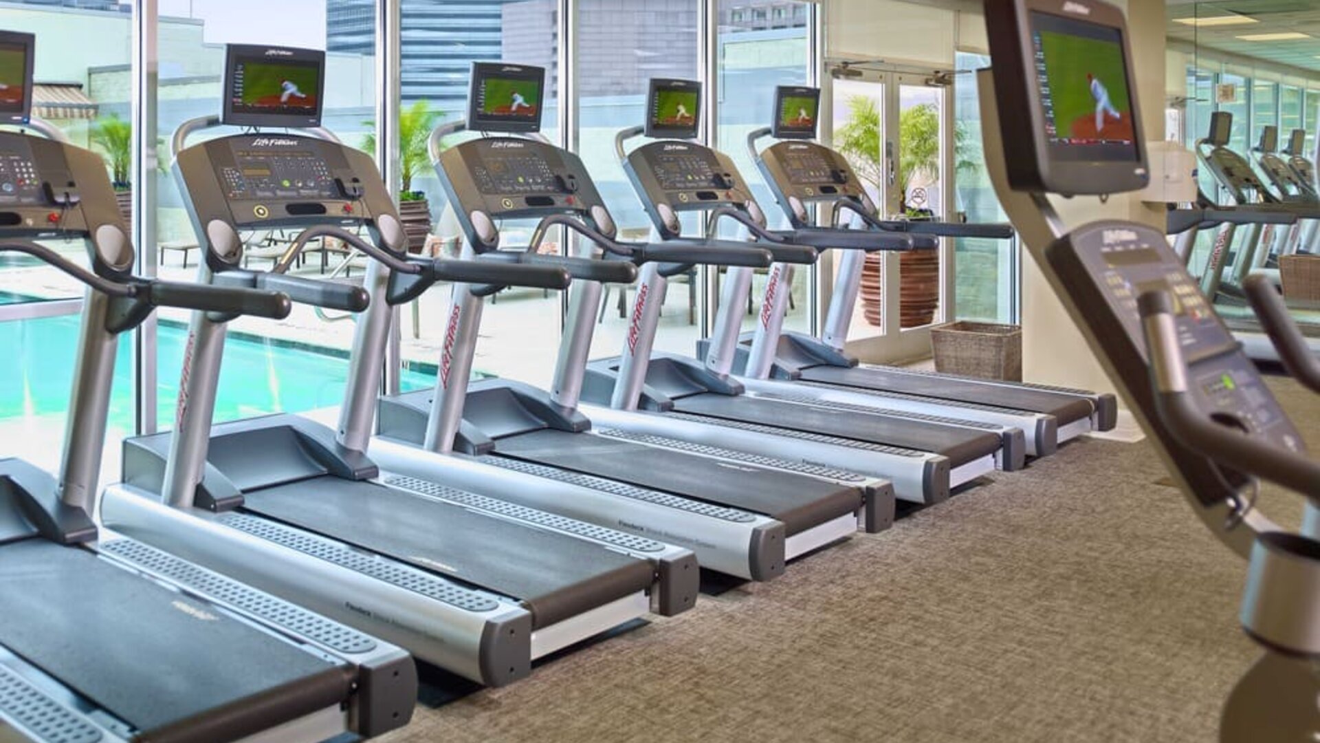The hotel fitness center has numerous treadmills and other exercise machines, and faces the pool.