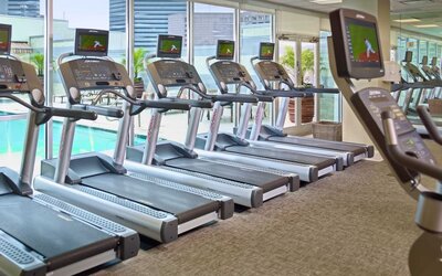 The hotel fitness center has numerous treadmills and other exercise machines, and faces the pool.