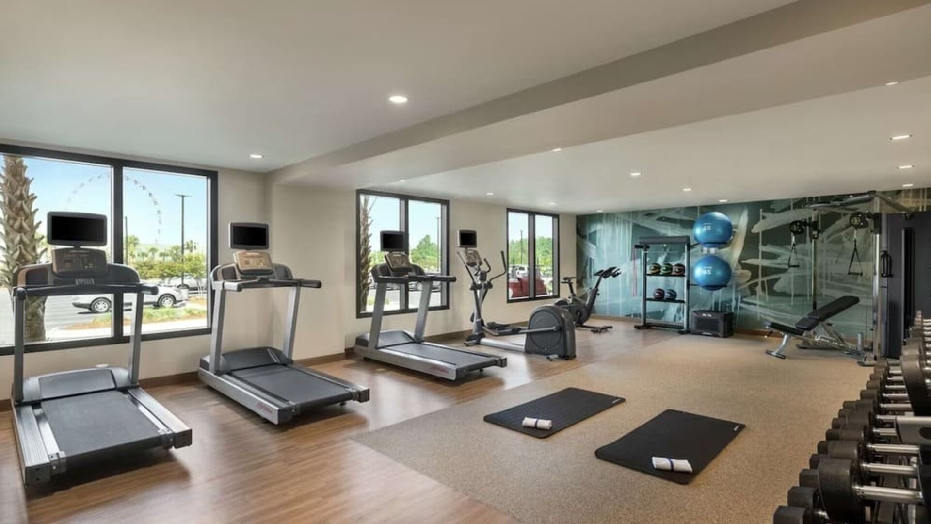 Fully equipped fitness center at Embassy Suites By Hilton Panama City Beach Resort.