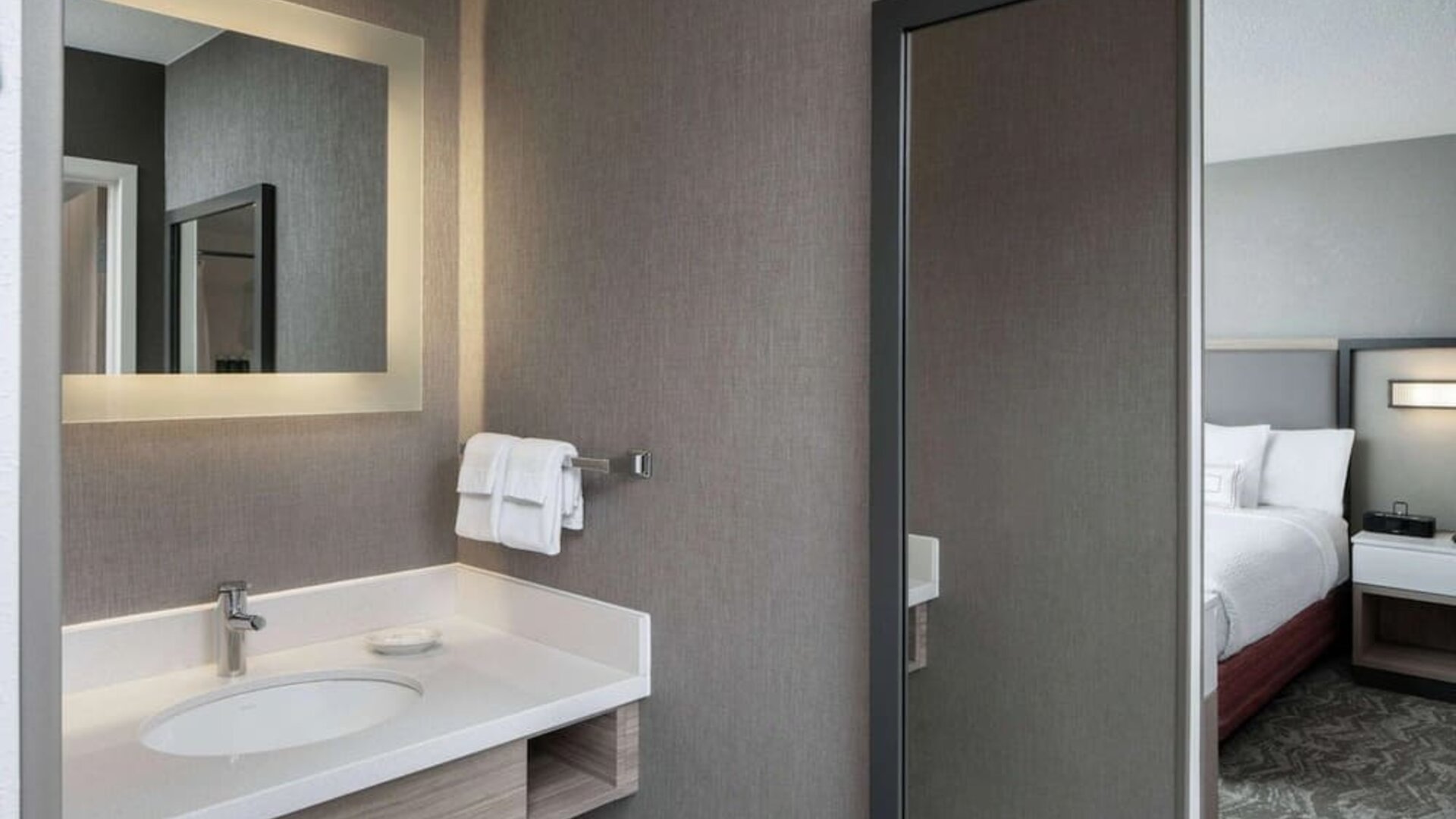 Sonesta Select Nashville Airport Suites double bed guest room, with ensuite bathroom.