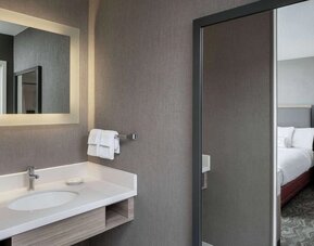 Sonesta Select Nashville Airport Suites double bed guest room, with ensuite bathroom.