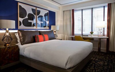 Royal Sonesta Washington DC Dupont Circle double bed guest room, featuring a window, and a workspace desk, chair, and lamp.