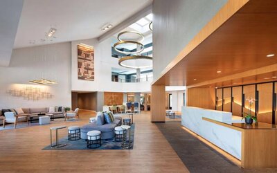 The hotel’s lobby lounge has comfy seating, coffee tables, and plenty of space for guests to socialize and co-work.