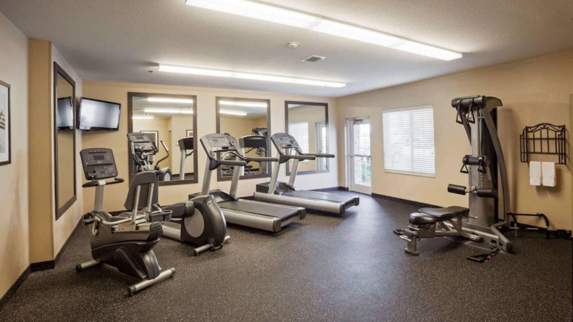 Sonesta Simply Suites Arlington’s fitness center is equipped with a widescreen TV and a range of exercise machinery.