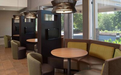 Sonesta Select Chattanooga Hamilton Place’s media pods offer cozy nooks for co-working with comfy seating, a TV, and coffee table each.
