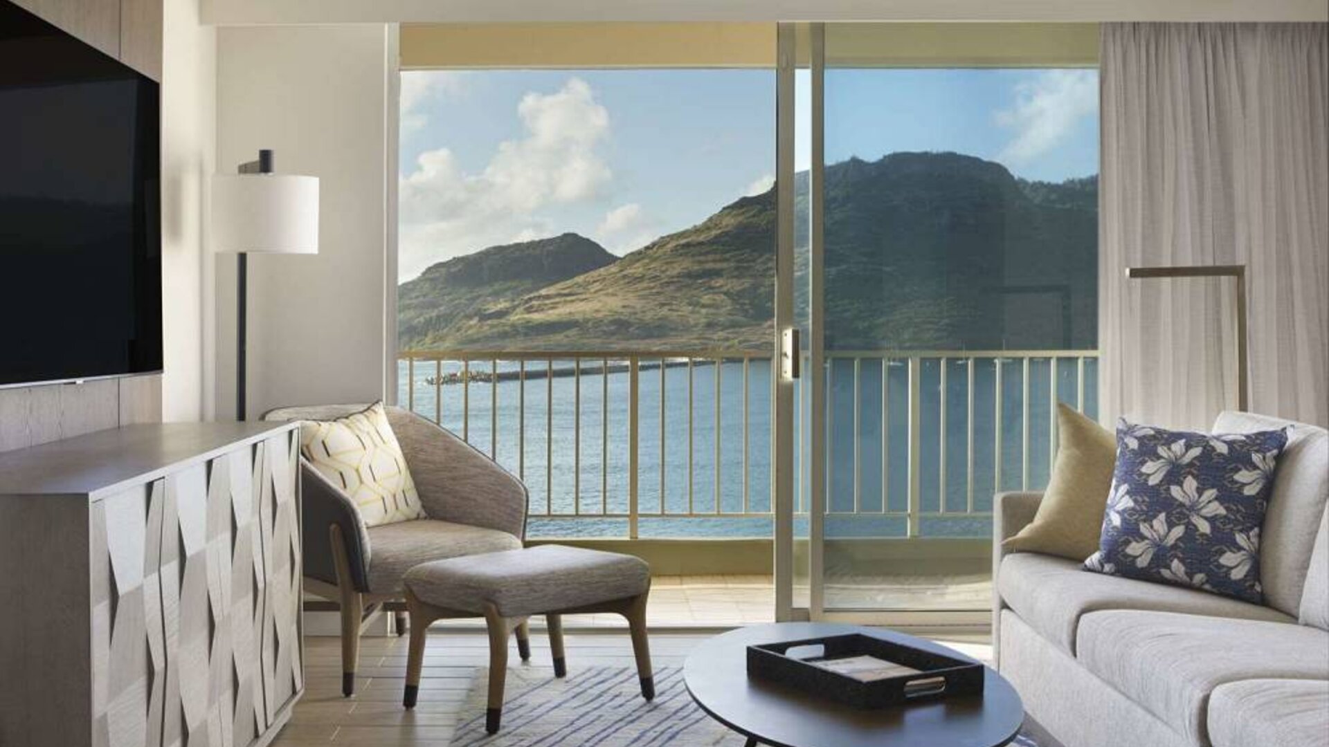 Royal Sonesta Kaua'i Resort Lihue guest room, furnished with sofa, coffee table, chair, and TV.