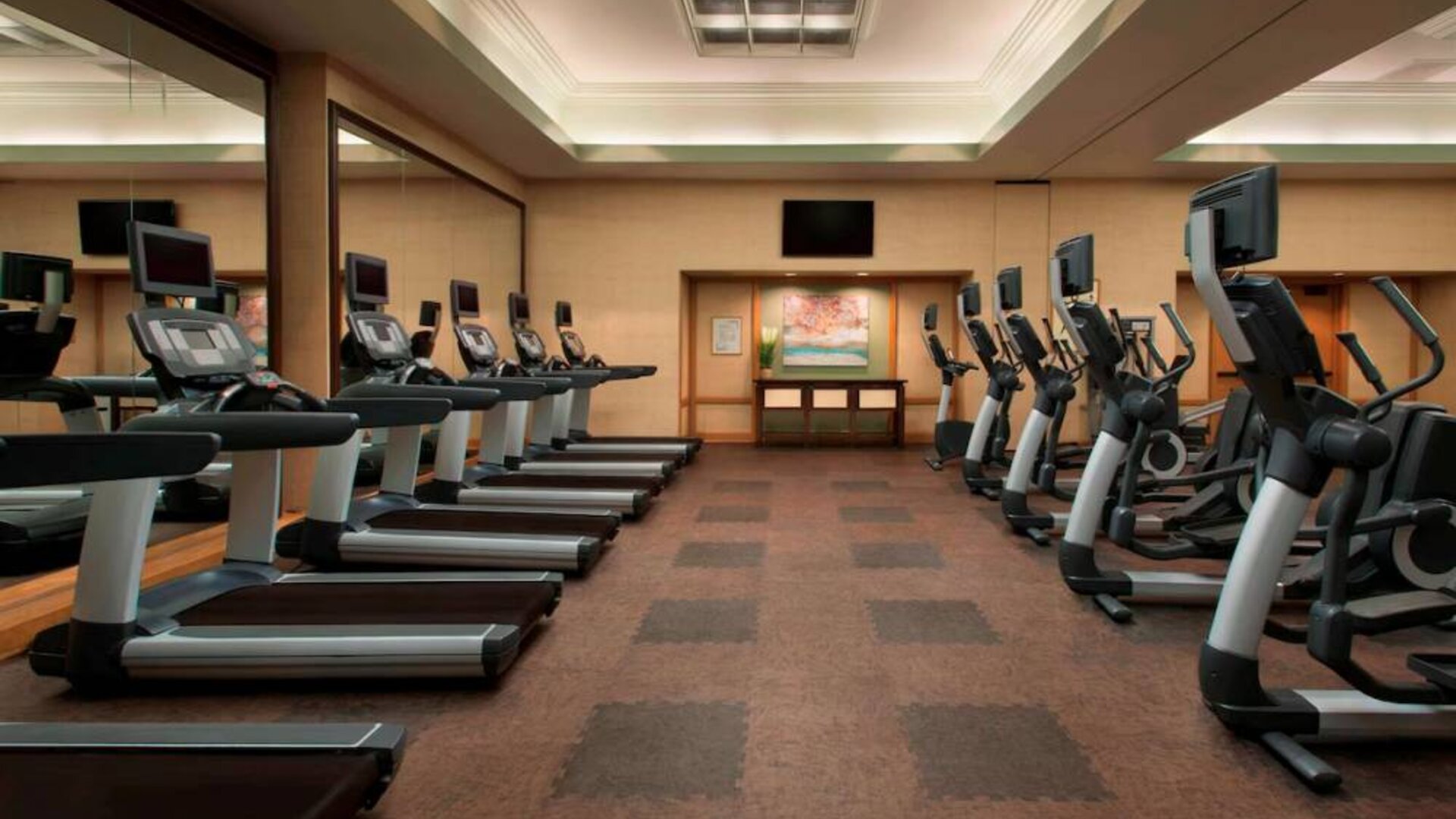 Royal Sonesta Kaua'i Resort Lihue’s fitness center has a large number of exercise machines and a wall-mounted widescreen television.