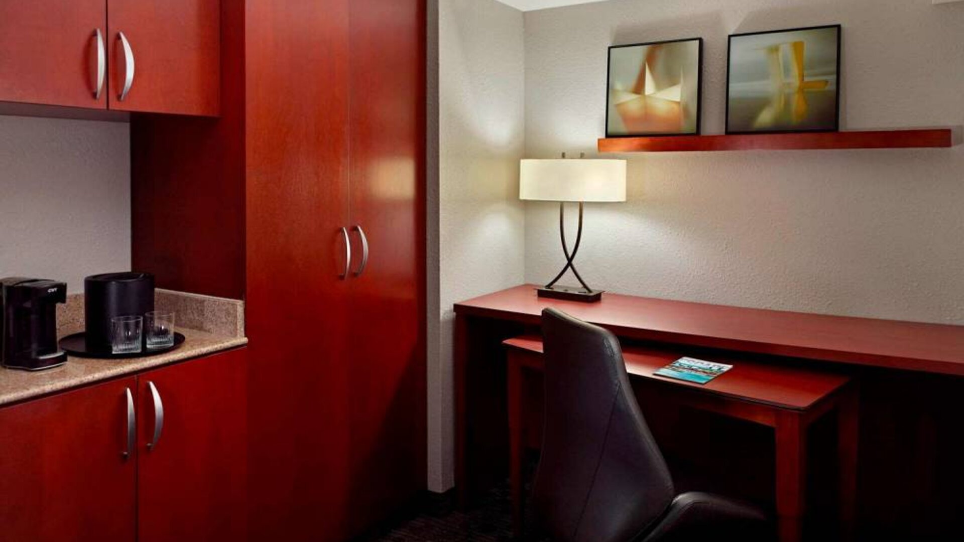 Sonesta Select Atlanta Cumberland Galleria guest room workspace, including desk, chair, and lamp.