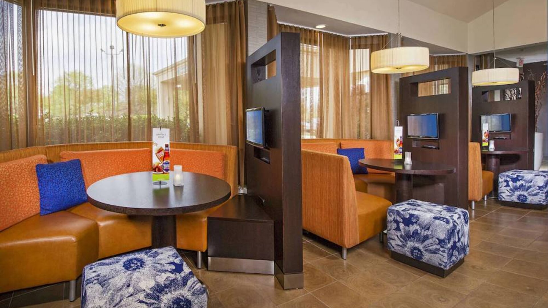 The hotel’s meeting pods provide comfortable seating with televisions and coffee tables for guests to socialize and work.