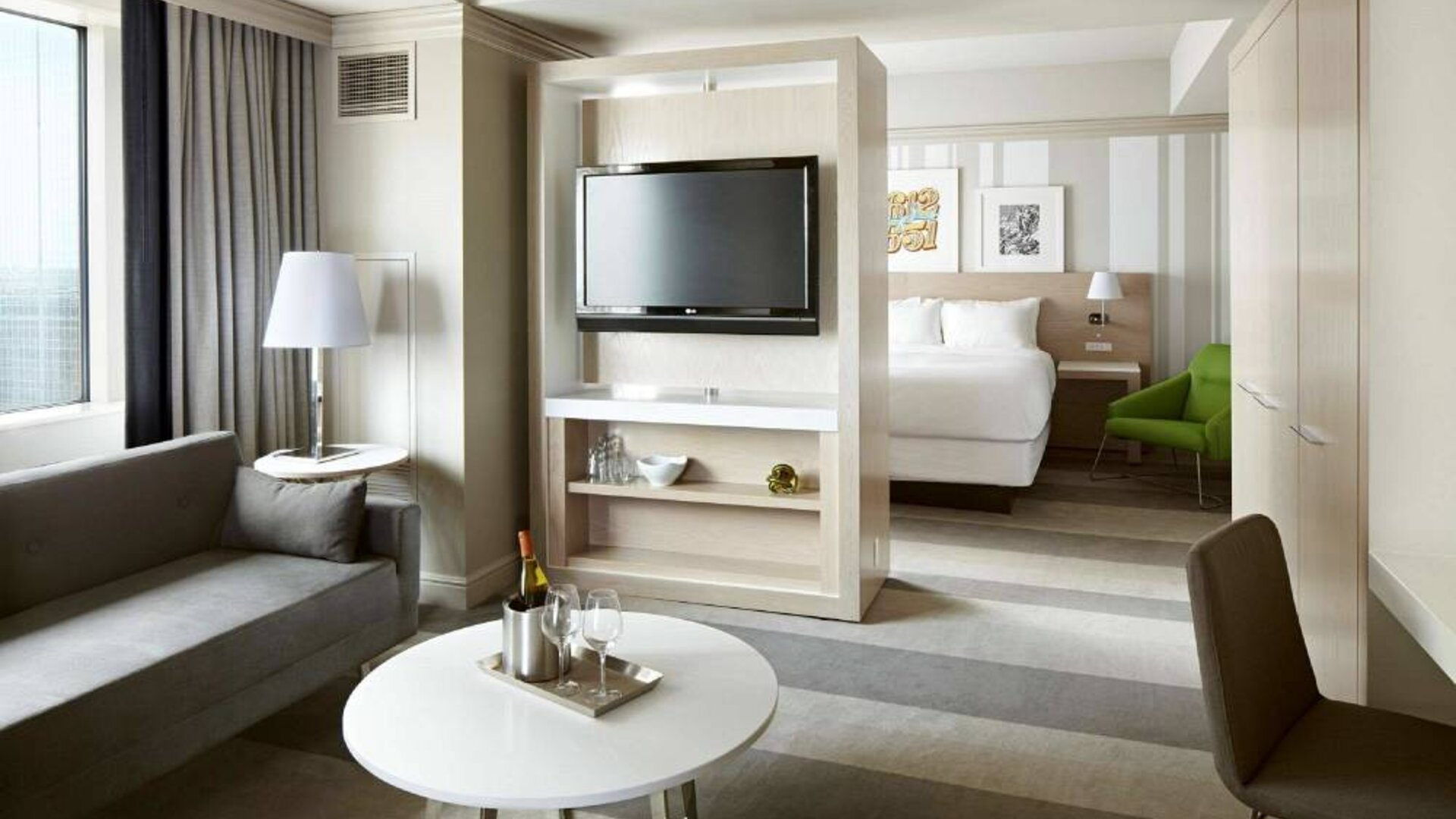 Royal Sonesta Minneapolis Downtown double bed day room, including sofa, TV, and coffee table.