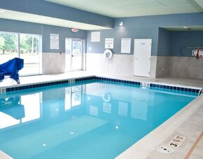Indoor pool with chairs at Holiday Inn Express & Suites Bensenville - O'Hare.