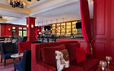 The Stephen F Austin Royal Sonesta Hotel’s bar has vibrant red decor, and a mix of comfortable table seating and traditional bar stools.