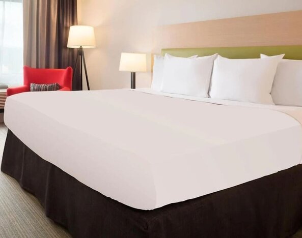 King bed with natural light at Country Inn & Suites By Radisson, Chicago O'Hare South.