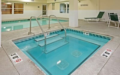 Relaxing indoor pool area at Country Inn & Suites By Radisson, Chicago O'Hare South.