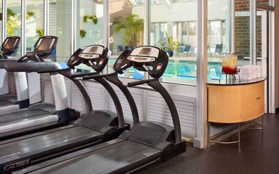 The hotel fitness center has numerous exercise machines and is adjacent to the indoor pool.