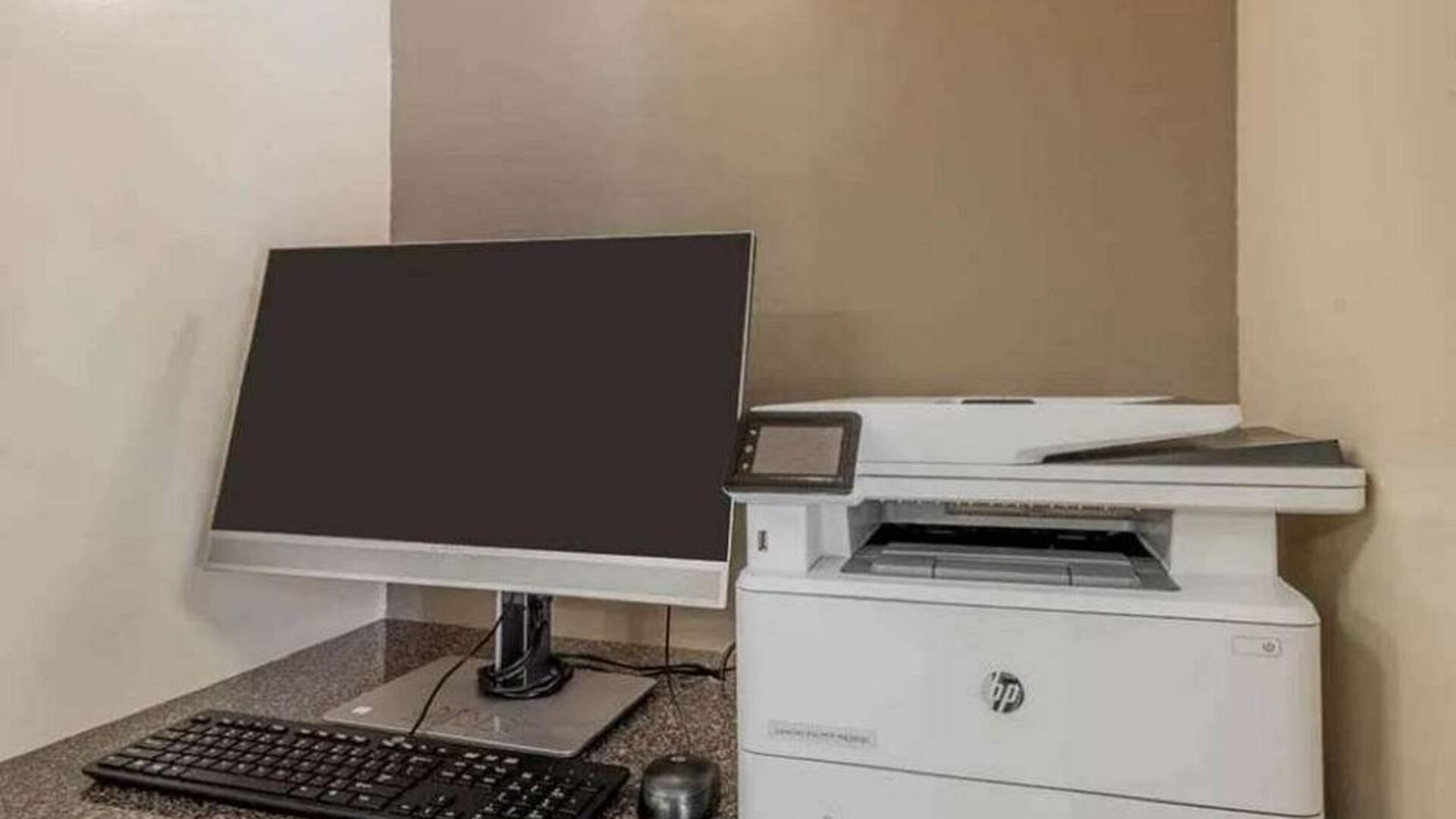 The hotel business center includes monitor, keyboard, and mouse, plus a printer.