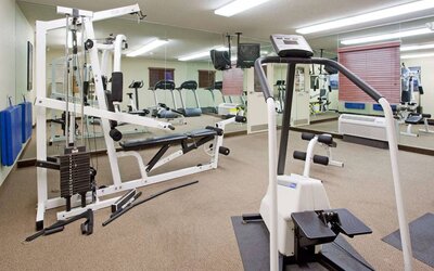 Sonesta Simply Suites Salt Lake City Airport’s fitness center has a diverse array of exercise machines and a television set.