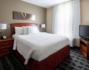 Double bed guest room in Sonesta Simply Suites Seattle Renton, featuring a large window and widescreen television.