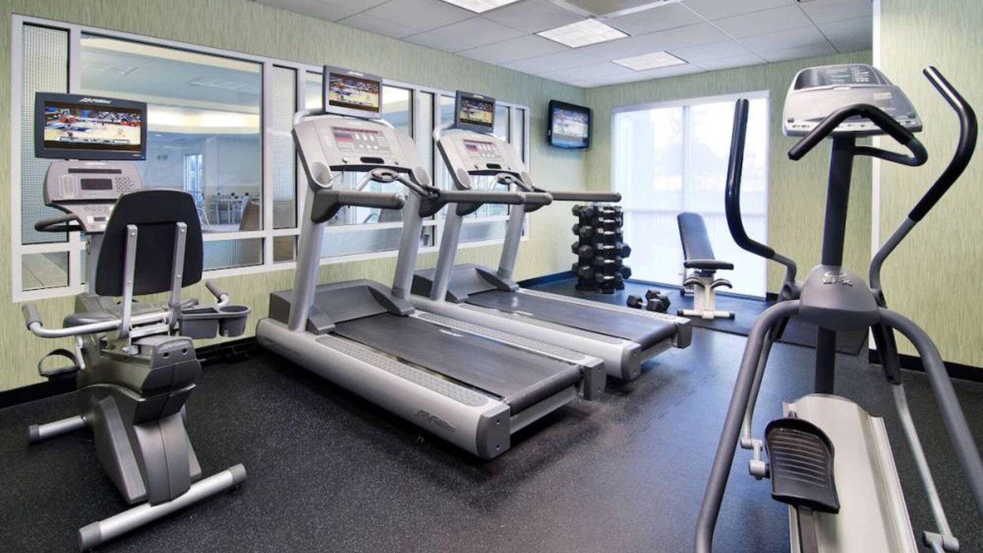 Sonesta Select Seattle Renton’s fitness center is equipped with both free weights and a variety of exercise machines, and has large windows.