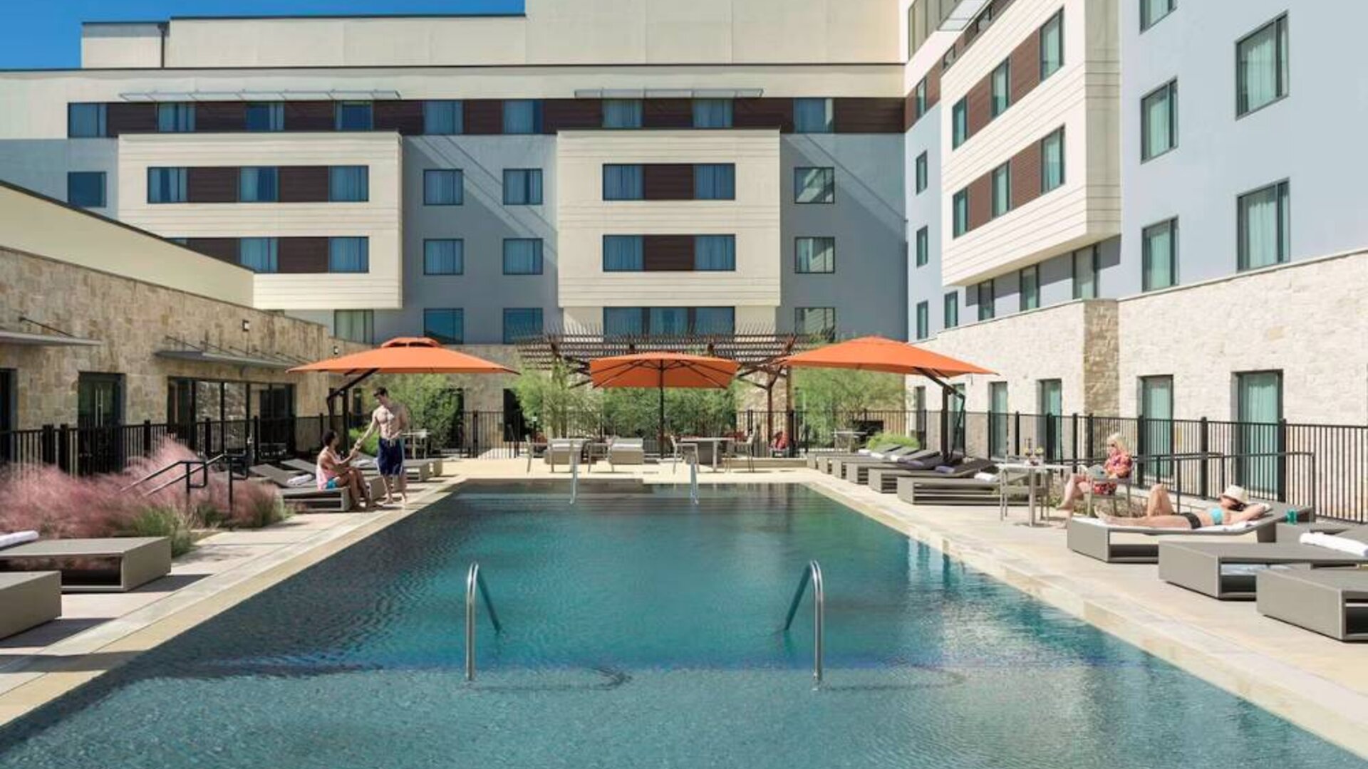 Sonesta Bee Cave Austin’s outdoor pool has sun loungers by the side and shaded seating just a few feet away.