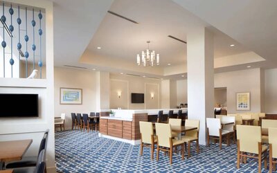 Sonesta ES Suites New Orleans’s cozy social space, The Nest, is the perfect place to rest and relax at tables large and small, or watch one of the wall-mounted televisions.