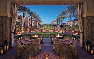 Sonesta Suites Scottsdale Gainey Ranch’s fire pits are surrounded by comfy chairs, with more tables and chairs, and candle-style lights, nearby for outdoor socializing.