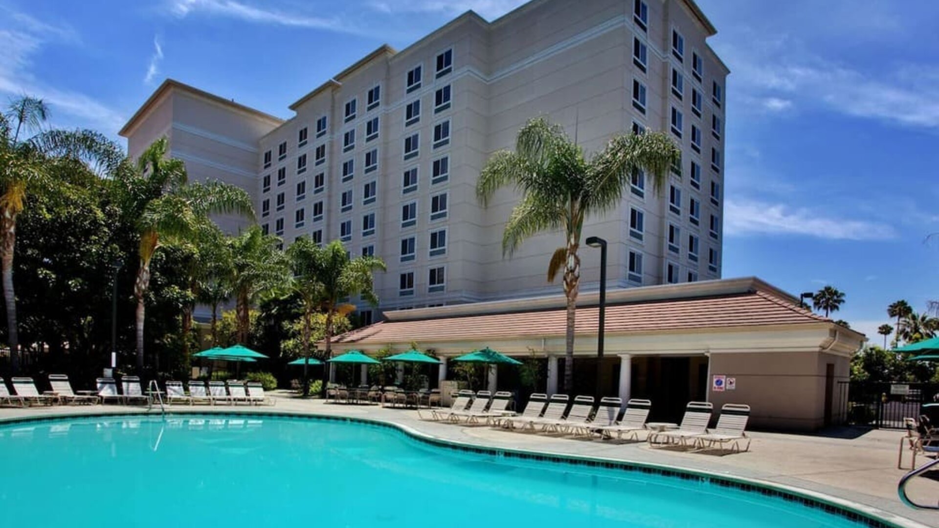 Outdoor pool with pool chairs at Sonesta Anaheim Resort Area.