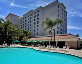 Outdoor pool with pool chairs at Sonesta Anaheim Resort Area.