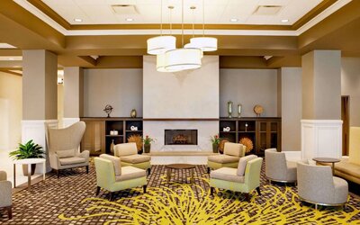The hotel’s lobby lounge includes a fireplace, armchairs and coffee tables set in a spacious environment.