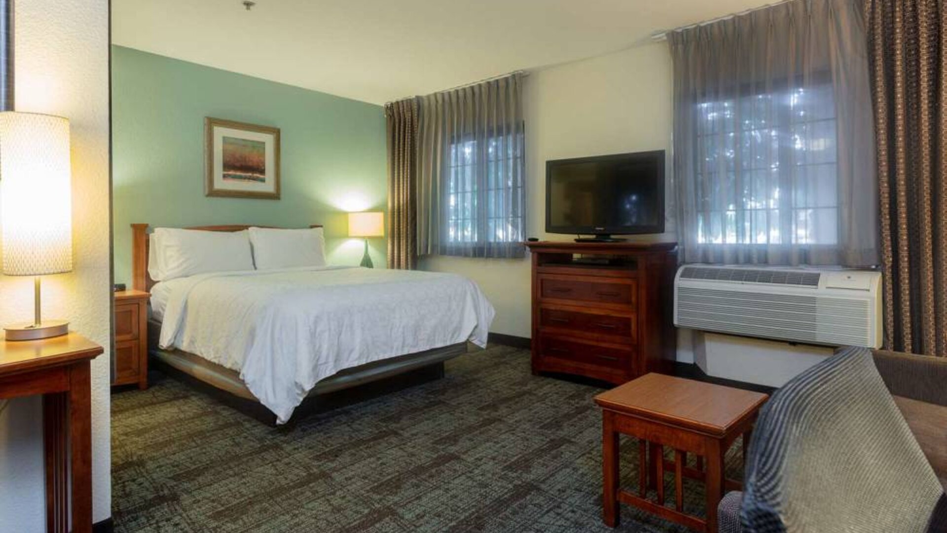 Double bed guest room in Sonesta ES Suites Anaheim Resort Area, including two windows, coffee table, and a television.