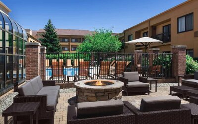 Sonesta Select Newport Middletown’s fire pit has comfortable armchair and sofa seating nearby, and is close to the pool.