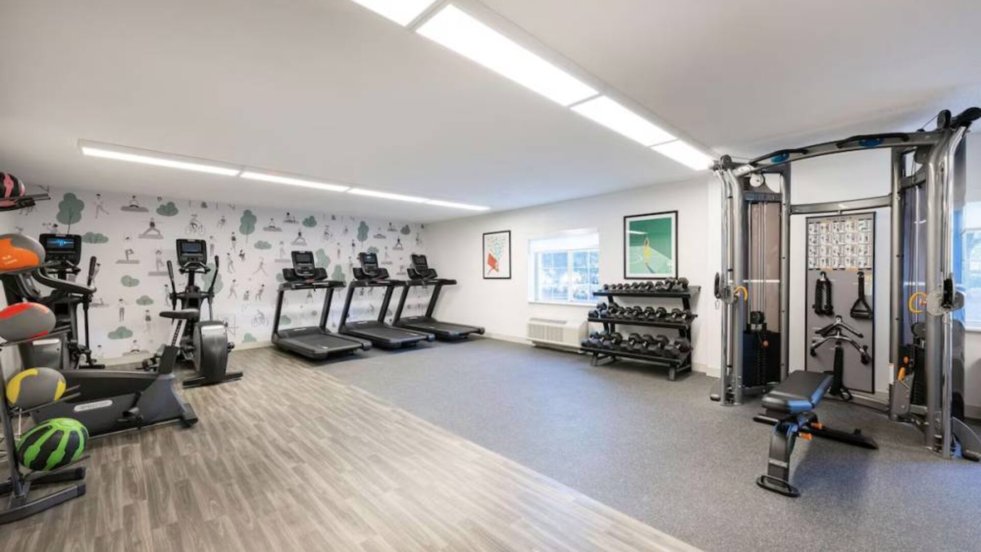 Sonesta Simply Suites Jersey City’s fitness center is equipped with free weights, a variety of exercise machines, gym balls, and art on the walls.