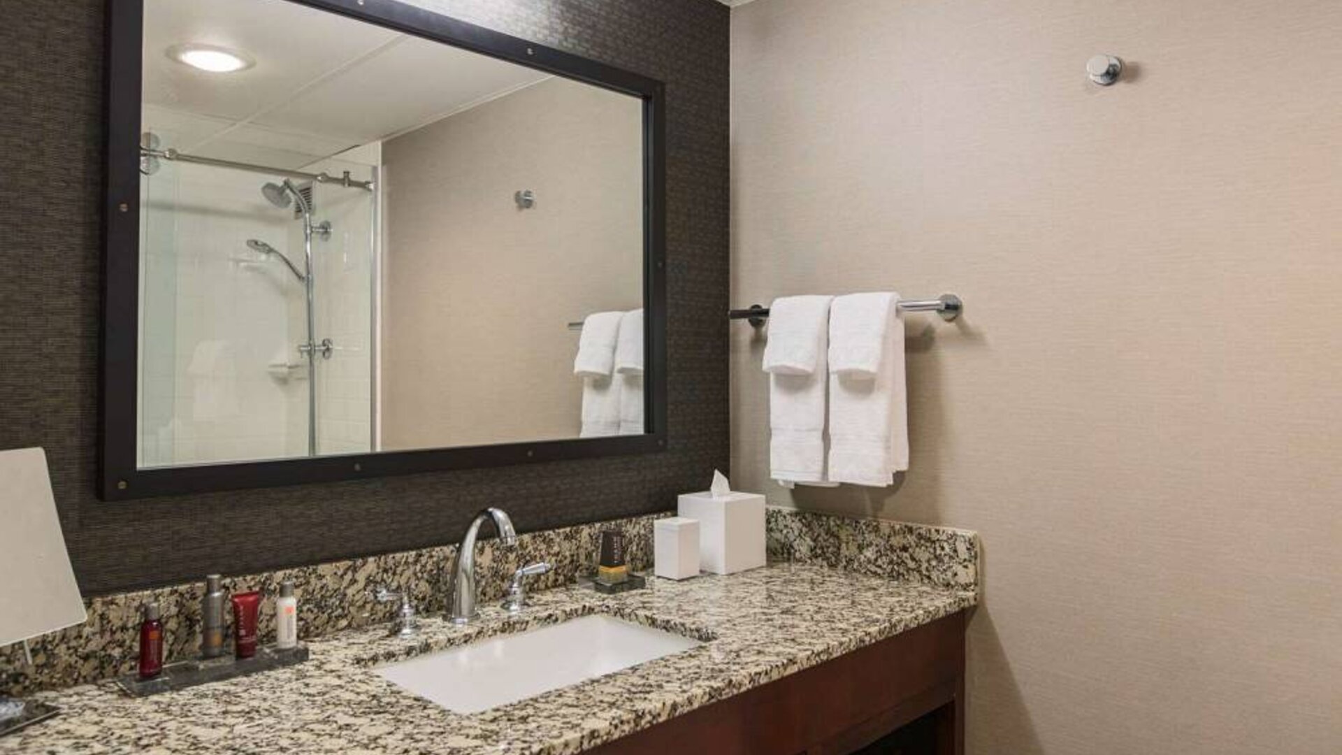 Sonesta Nashville Airport guest bathroom, with shower, sink, and mirror.