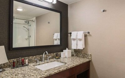 Sonesta Nashville Airport guest bathroom, with shower, sink, and mirror.