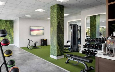 Sonesta Irvine’s fitness center is equipped with both exercise machines and free weights, in addition to gym balls and nature-themed decor.