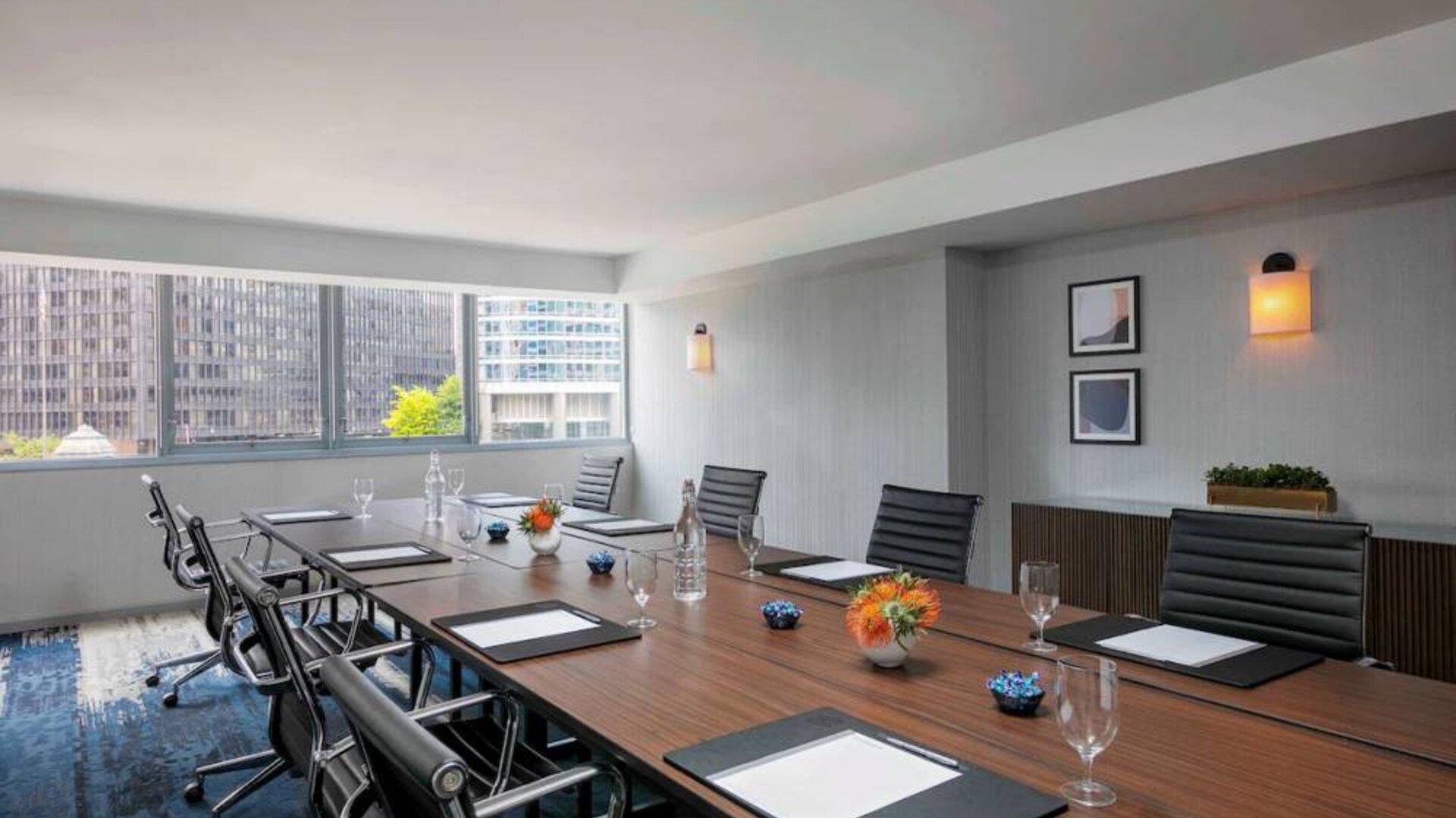 Royal Sonesta Chicago Downtown meeting room, including long table and swivel chairs, with views of the urban landscape.