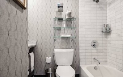 Guest bathroom in The Allegro Royal Sonesta Hotel Chicago Loop, featuring bath and shower, and a lavatory.