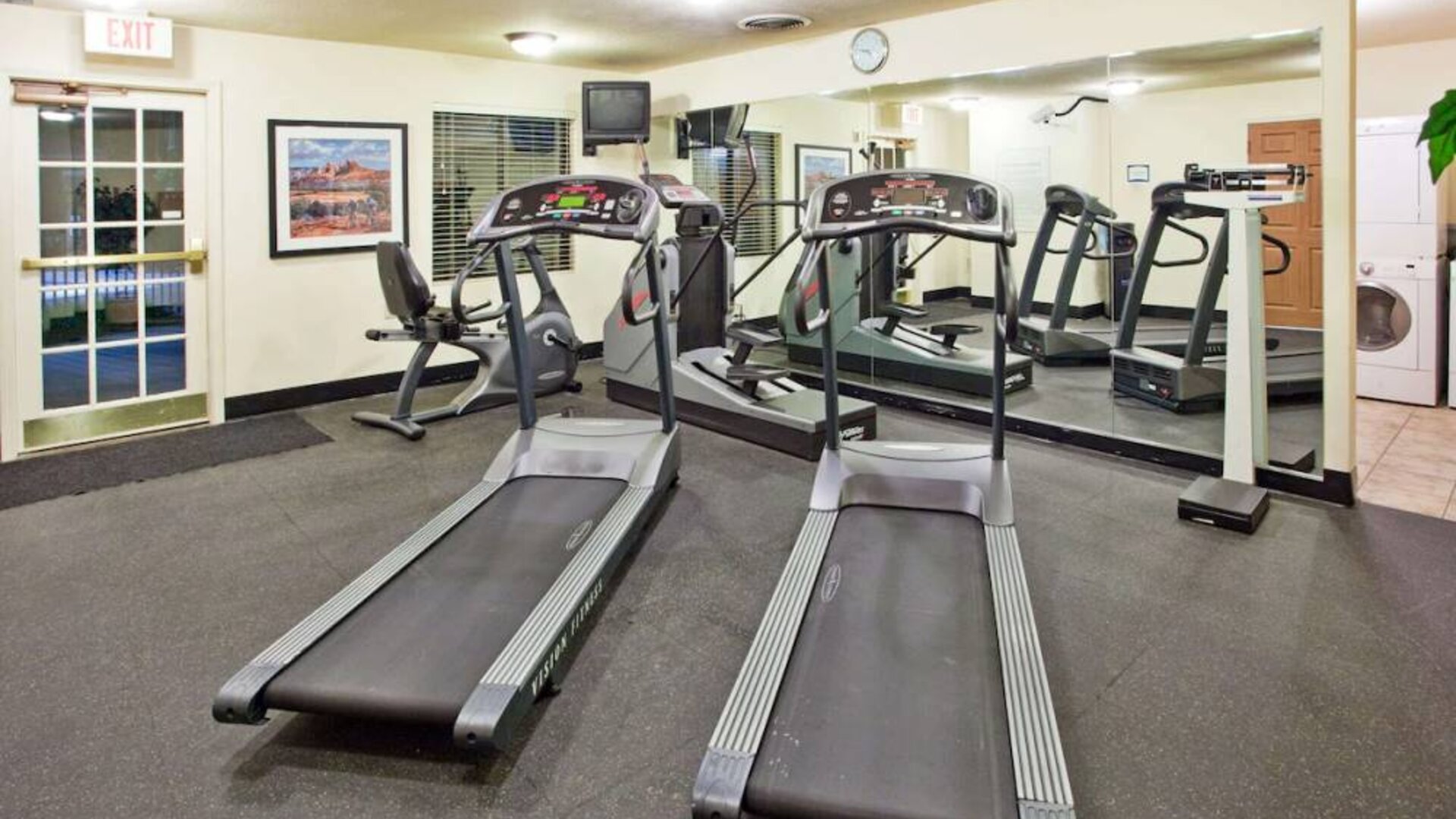 Sonesta ES Suites Atlanta Alpharetta Avalon’s fitness center is equipped with a range of exercise machinery and a wall-mounted television.