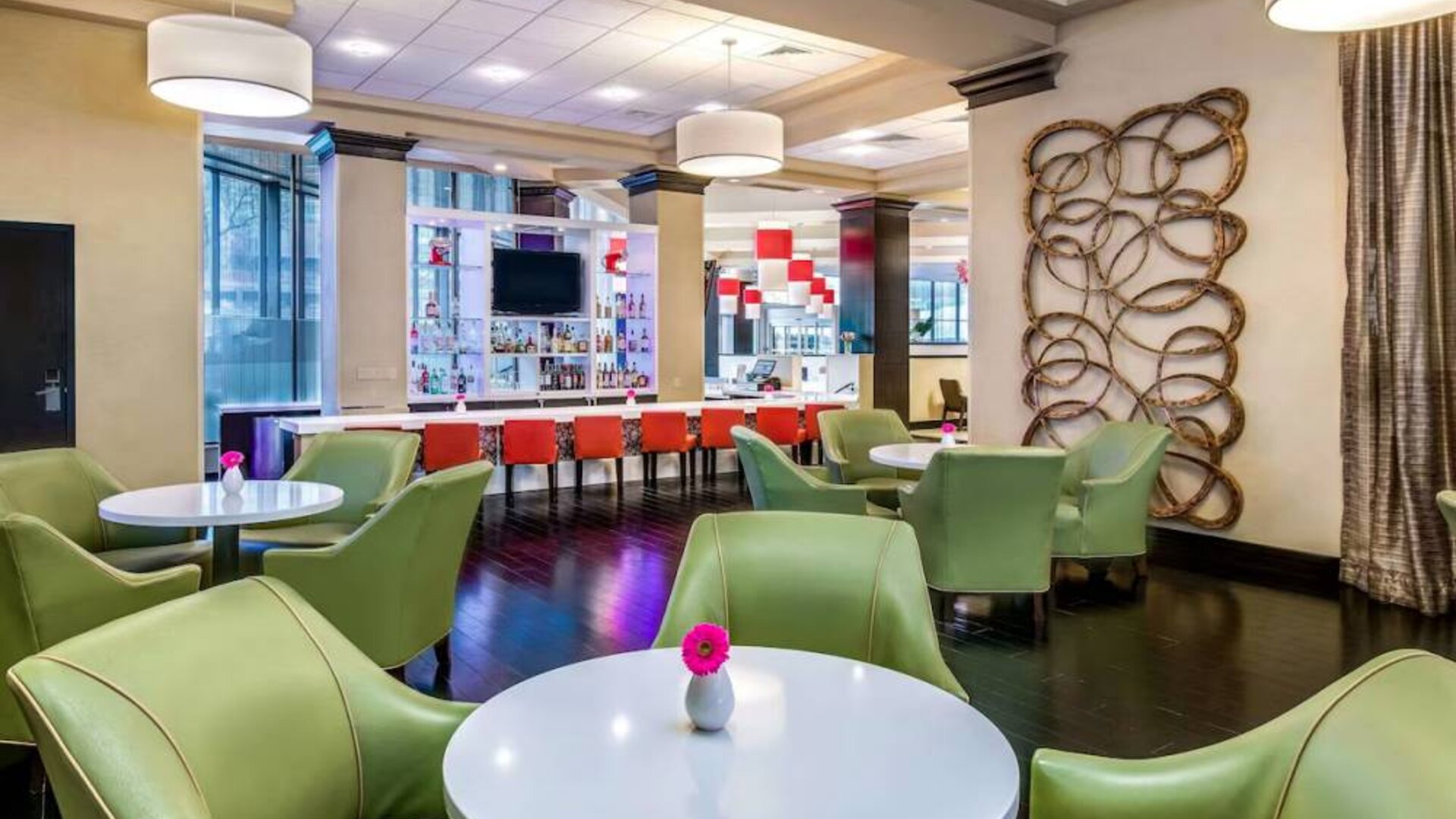 The hotel’s bar has a mix of bar stools and table seating, a hard floor, widescreen TV, and range of refreshing beverages.