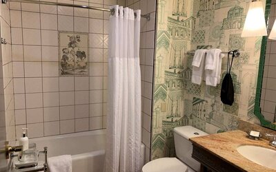 Guest bathroom in Royal Sonesta Portland Downtown, including sink, mirror, lavatory, and bath.