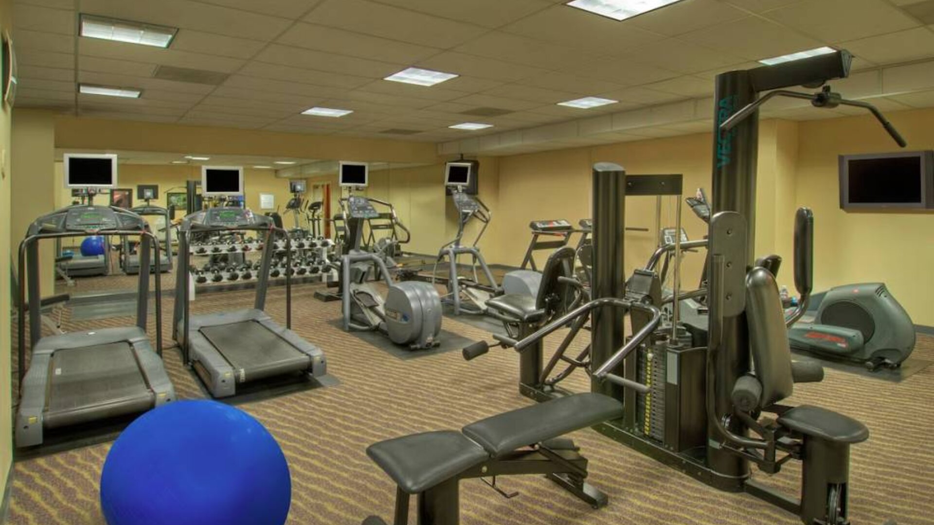 Royal Sonesta Portland Downtown’s fitness center is equipped with free weights, a wall-mounted TV, and assorted exercise machines.