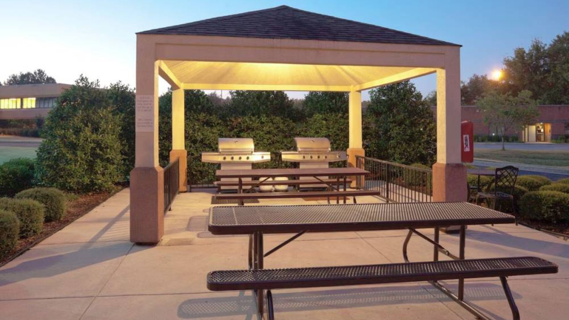 The gazebo at Sonesta Simply Suites Dallas Las Colinas includes barbecue facilities and picnic tables and benches where guests can dine and socialize.