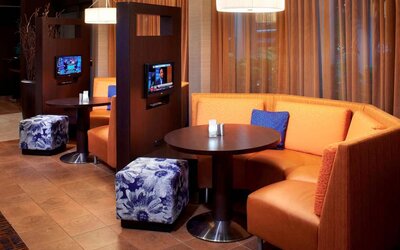 The media pods at Sonesta Select Detroit Auburn Hills are cozy nooks, with each featuring comfy seating, a coffee table, and a TV.