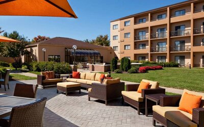 The hotel’s patio has armchairs and sofas, with coffee tables, as well as shaded tables and chairs.
