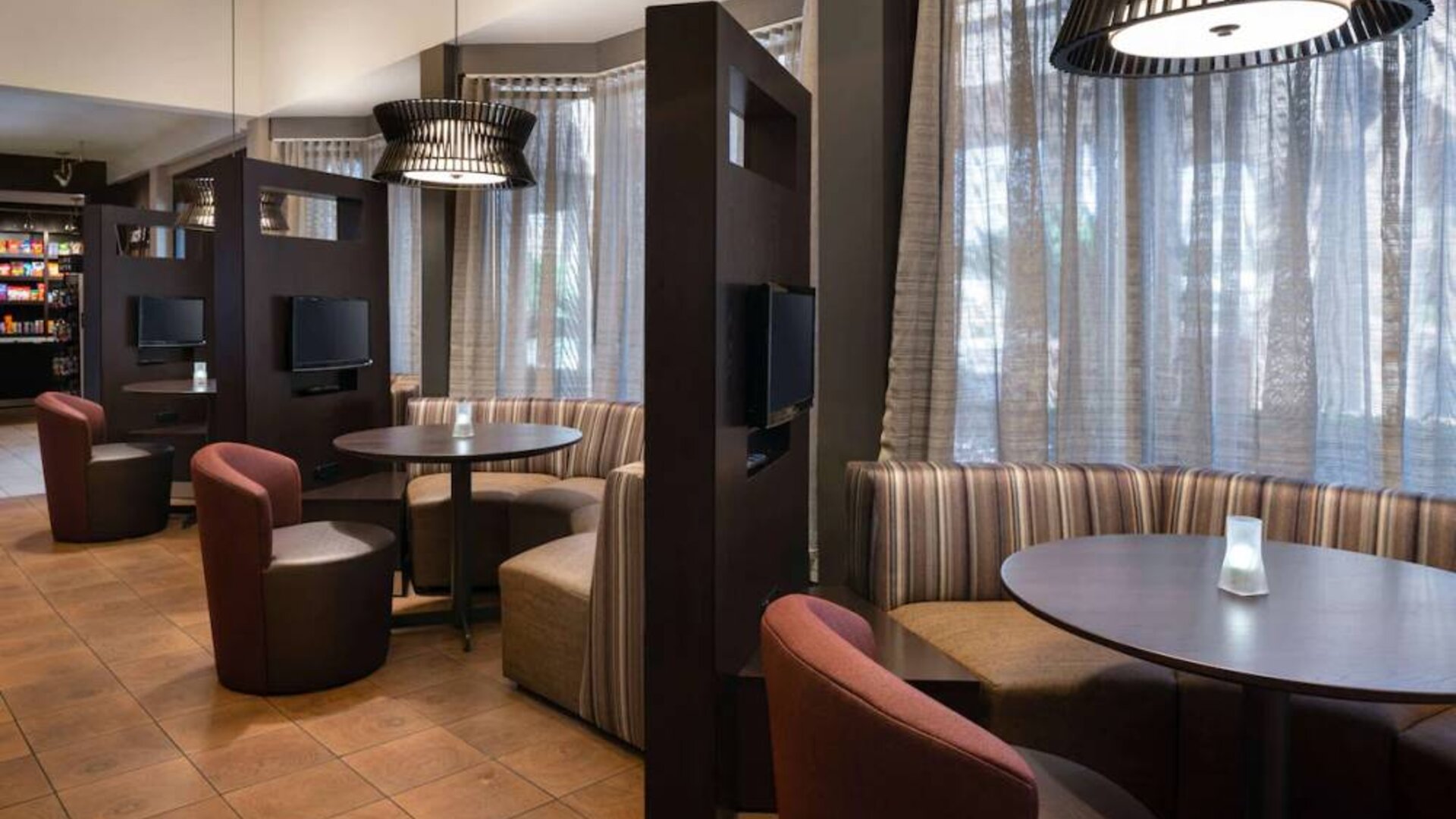 The hotel’s media pods offer a cozy space for co-working, and each has comfy seating, a coffee table, and a television.