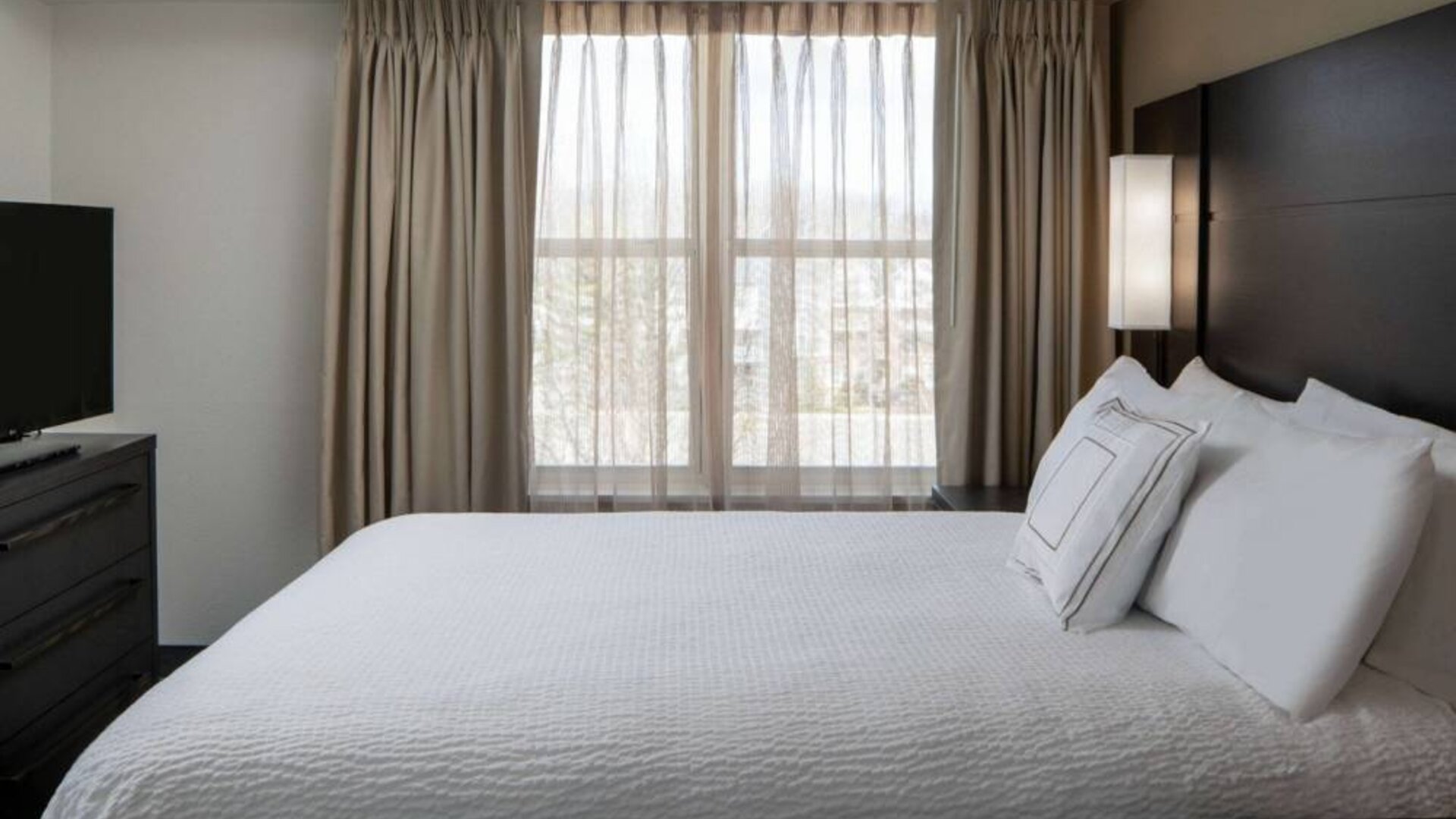 Double bed guest room in Sonesta ES Suites Fairfax Fair Lakes, featuring TV and a window.