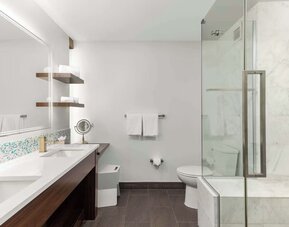 Private guest bathroom with shower at The Art Hotel Denver.