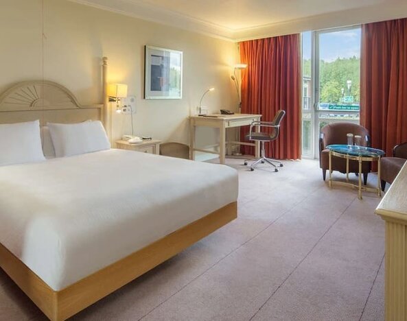 King bed with TV and natural light at Hilton Leicester.
