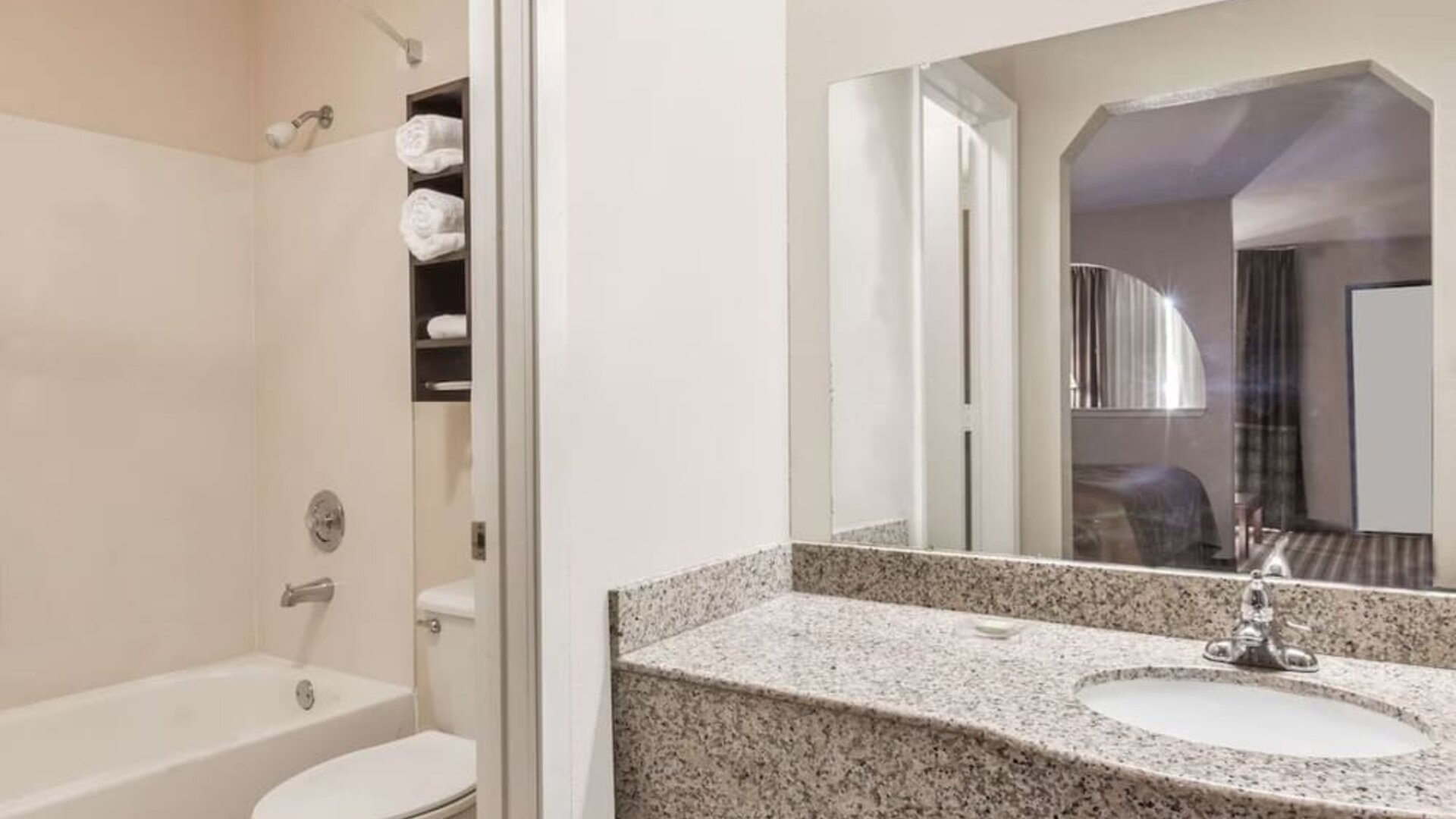 Guest bathroom with shower and bath at Super 8 By Wyndham Houston/Webster.